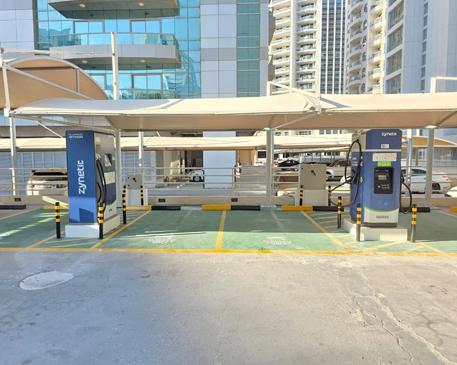 Two Zynetic chargers under a canopy on green bays
